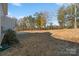 Large backyard with sloped lawn and wooded area at 4551 Selhurst Dr, Indian Land, SC 29707