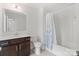 Bright bathroom with a single vanity, tile floors, and a shower-tub combination with a curtain at 4551 Selhurst Dr, Indian Land, SC 29707