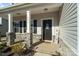 Inviting front porch with stone columns and a charming entryway at 4551 Selhurst Dr, Indian Land, SC 29707