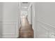 The hallway features wainscotting, hardwood floors, and access to multiple rooms in the home at 4551 Selhurst Dr, Indian Land, SC 29707