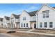 Exterior view of townhomes with white siding, black doors, and landscaped front yards at 456 Berryman Rd, Rock Hill, SC 29732