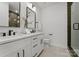 Modern bathroom with double vanity, large mirror, and glass shower at 520 Stegall St, Charlotte, NC 28217