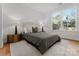 Bright bedroom with large window, stylish bed, and hardwood floors at 520 Stegall St, Charlotte, NC 28217