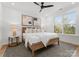 Spacious bedroom with wood bed frame, large windows, and ceiling fan at 520 Stegall St, Charlotte, NC 28217