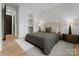 Cozy bedroom with a plush bed, stylish lamps, and hardwood floors at 520 Stegall St, Charlotte, NC 28217