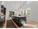 Bright kitchen featuring an island, light hardwood floors, and modern light fixtures at 520 Stegall St, Charlotte, NC 28217