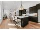 Modern kitchen with dark cabinetry, island, and hardwood floors at 520 Stegall St, Charlotte, NC 28217