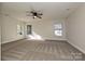 Spacious bedroom with carpet, ceiling fan and multiple windows at 1021 Kings Mountain Ln, Gastonia, NC 28054