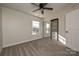 Bedroom with ceiling fan, window blinds, and mirrored closet at 1021 Kings Mountain Ln, Gastonia, NC 28054