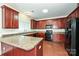 Kitchen with dark wood cabinets, granite countertops, and black appliances at 1021 Kings Mountain Ln, Gastonia, NC 28054