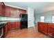 Kitchen with dark wood cabinets, granite countertops, and black appliances at 1021 Kings Mountain Ln, Gastonia, NC 28054