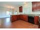 Kitchen with dark wood cabinets, granite countertops, and black appliances at 1021 Kings Mountain Ln, Gastonia, NC 28054