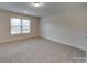 Spacious bedroom with neutral walls, carpet, and window at 15334 S Birkdale Commons Pkwy, Huntersville, NC 28078