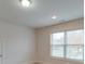 Well-lit bedroom with window, neutral walls and carpet at 15334 S Birkdale Commons Pkwy, Huntersville, NC 28078