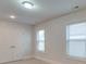 Bedroom with double doors and window, neutral walls and carpet at 15334 S Birkdale Commons Pkwy, Huntersville, NC 28078