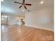 Open concept living area with hardwood floors, a view into the kitchen, and recessed lighting at 15334 S Birkdale Commons Pkwy, Huntersville, NC 28078