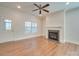 Living room with fireplace, hardwood floors, and a ceiling fan at 15334 S Birkdale Commons Pkwy, Huntersville, NC 28078