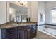 Elegant bathroom with granite countertop, dark cabinets and a soaking tub at 5110 Pansley Dr, Charlotte, NC 28226