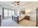 Spacious bedroom with large windows, hardwood floors, and a ceiling fan at 5110 Pansley Dr, Charlotte, NC 28226