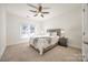 Bright bedroom with ceiling fan, neutral walls, and carpeted floors at 5110 Pansley Dr, Charlotte, NC 28226