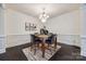 Dining area with marble table, chandelier, and dark hardwood floors at 5110 Pansley Dr, Charlotte, NC 28226