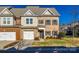 Two-story townhome with two-car garage and manicured lawn at 5110 Pansley Dr, Charlotte, NC 28226