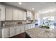 Open concept kitchen with granite countertops and white cabinetry at 5110 Pansley Dr, Charlotte, NC 28226