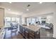 Open concept kitchen with island, granite countertops, and views into the living room at 5110 Pansley Dr, Charlotte, NC 28226