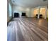 Bright and airy living room features hardwood floors and a stone fireplace with a dining area at 5110 Pansley Dr, Charlotte, NC 28226