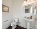 Modern powder room with pedestal sink and dark tile floor at 5110 Pansley Dr, Charlotte, NC 28226