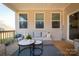 Relaxing back porch with wicker furniture and potted plants at 5120 Kings Pinnacle Dr, Kings Mountain, NC 28086