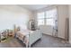 Bright bedroom featuring a twin bed, bookshelf, and window with curtains at 5120 Kings Pinnacle Dr, Kings Mountain, NC 28086