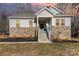 House exterior featuring stone and siding accents, a front porch, and landscaping at 5120 Kings Pinnacle Dr, Kings Mountain, NC 28086