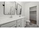 Bathroom with dual sinks, framed mirrors, a walk-in shower, a toilet, and gray tile flooring at 547 Old Mill Rd, Charlotte, NC 28206