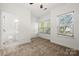 Bedroom featuring neutral carpeting, white walls and trim, a private bathroom, and three windows at 547 Old Mill Rd, Charlotte, NC 28206