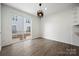 Bright dining area features modern lighting, wood floors, and sliding glass doors to the outdoor patio at 547 Old Mill Rd, Charlotte, NC 28206