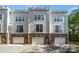 Townhouse complex featuring three garage doors and brick and siding facade at 547 Old Mill Rd, Charlotte, NC 28206