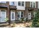 Brick townhouse with a cozy front porch and decorative details at 547 Old Mill Rd, Charlotte, NC 28206