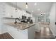 Open kitchen featuring white cabinets, stainless steel appliances, granite countertops, and hardwood floors at 547 Old Mill Rd, Charlotte, NC 28206