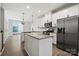 Bright kitchen featuring white cabinets, stainless steel appliances, granite countertops, and hardwood floors at 547 Old Mill Rd, Charlotte, NC 28206