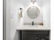 Small bathroom with modern vanity and round mirror at 6239 Oxwynn Ln, Charlotte, NC 28270