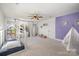 Spacious bedroom with purple accent wall and ample natural light at 6239 Oxwynn Ln, Charlotte, NC 28270