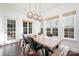 Sunlit dining area with large wooden table and bench seating at 6239 Oxwynn Ln, Charlotte, NC 28270