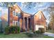 Brick home with a two car garage and manicured lawn at 6239 Oxwynn Ln, Charlotte, NC 28270