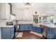 Modern kitchen with blue cabinets and farmhouse sink at 6239 Oxwynn Ln, Charlotte, NC 28270