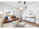 Living room with leather couch, coffee table, and view of the front yard at 7420 Gwynne Cir, Charlotte, NC 28214