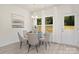 Elegant dining room with glass table, beige chairs, and natural light at 8508 Sunflower Rd, Charlotte, NC 28227