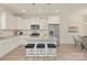 Modern kitchen with white cabinets, granite island, and stainless steel appliances at 8508 Sunflower Rd, Charlotte, NC 28227