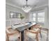 Dining room boasts a modern chandelier, wainscoting, and large windows for natural light at 1312 Pleasant Plains Rd, Matthews, NC 28105