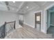 Hallway with hardwood floors, decorative railings, and coffered ceiling that adds a modern yet elegant touch to the home at 1312 Pleasant Plains Rd, Matthews, NC 28105